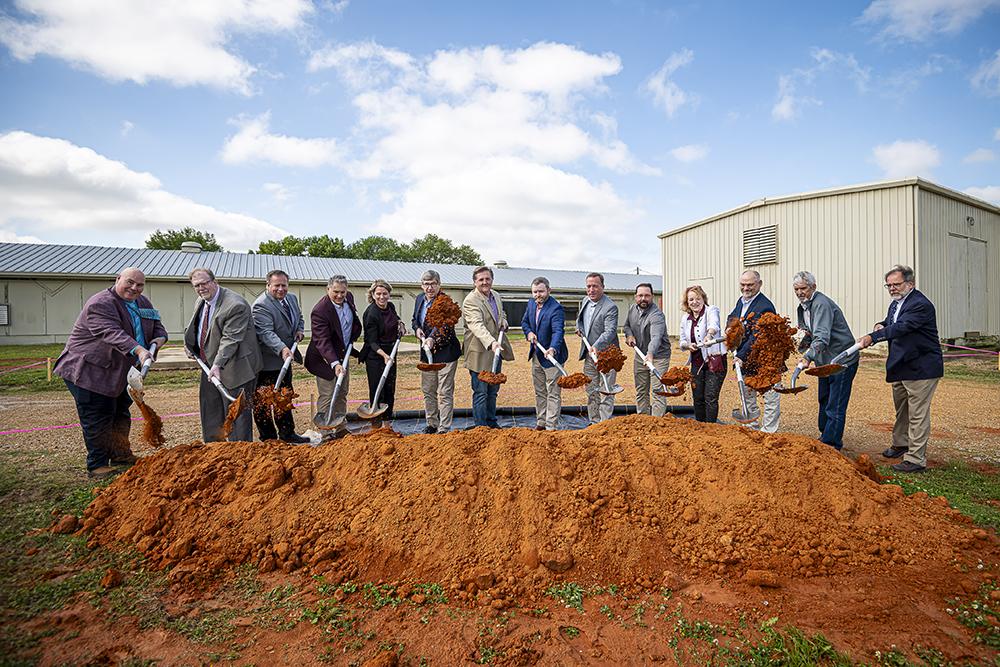 Team celebrating the groundbreaking of new feed mill.